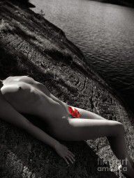 2508506_Nude_Woman_Lying_On_Rocks_By_The_Water