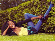 6970221_Young_Happy_Black_Woman_Lying_On_The_Grass